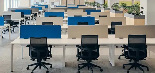 Modern open-plan office space featuring clean workstations, ergonomic chairs, and sanitized carpets provided by professional office cleaning services in Pittsburgh, PA.