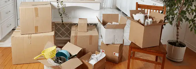 Packed moving boxes and household items in a kitchen before move-out or move-in cleaning, Pittsburgh, PA.